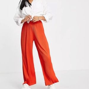 Women’s petite, wide/flare leg, bright red trousers.